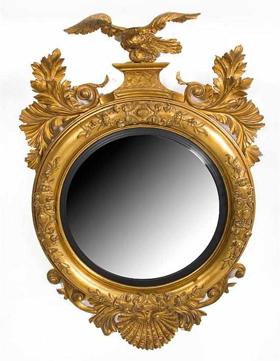 Appraisal: Federal style giltwood convex mirror spread-wing eagle pediment flanked by