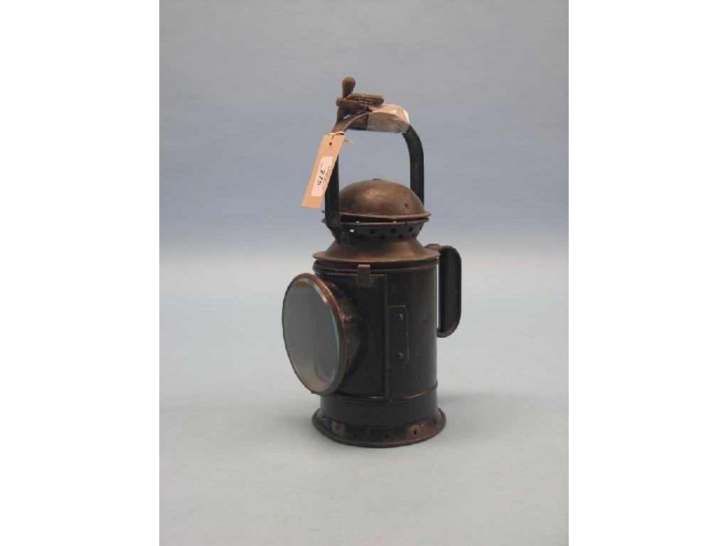 Appraisal: A vintage hand-held railway lamp painted tinplate spirit-fired in