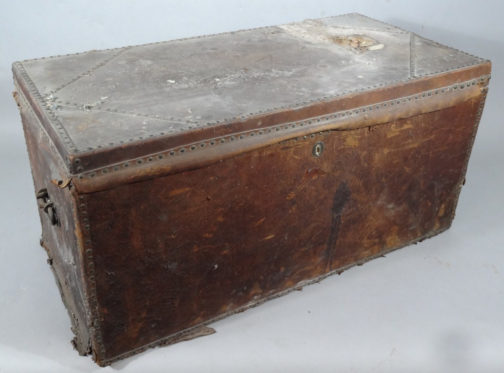 Appraisal: A pressed leather wooden bound travel trunk of rectangular outline