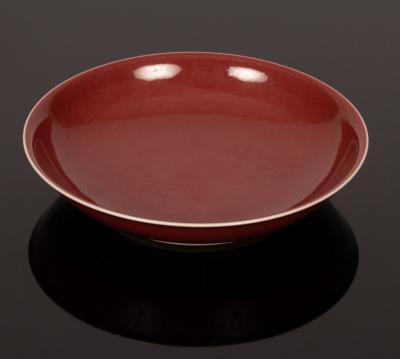 Appraisal: A Chinese monochrome saucer th Century in underglaze red Hongyou