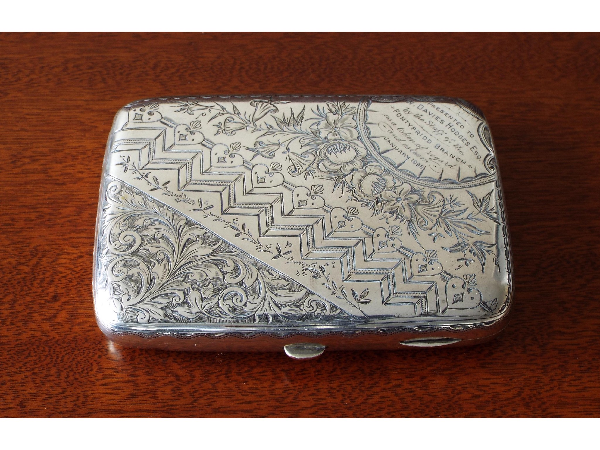 Appraisal: Victorian silver hip-shaped cigar case extensively engraved with bands of