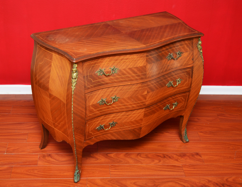 Appraisal: BOMBAY ORMOLU CHEST Shaped top string inlay on top sides