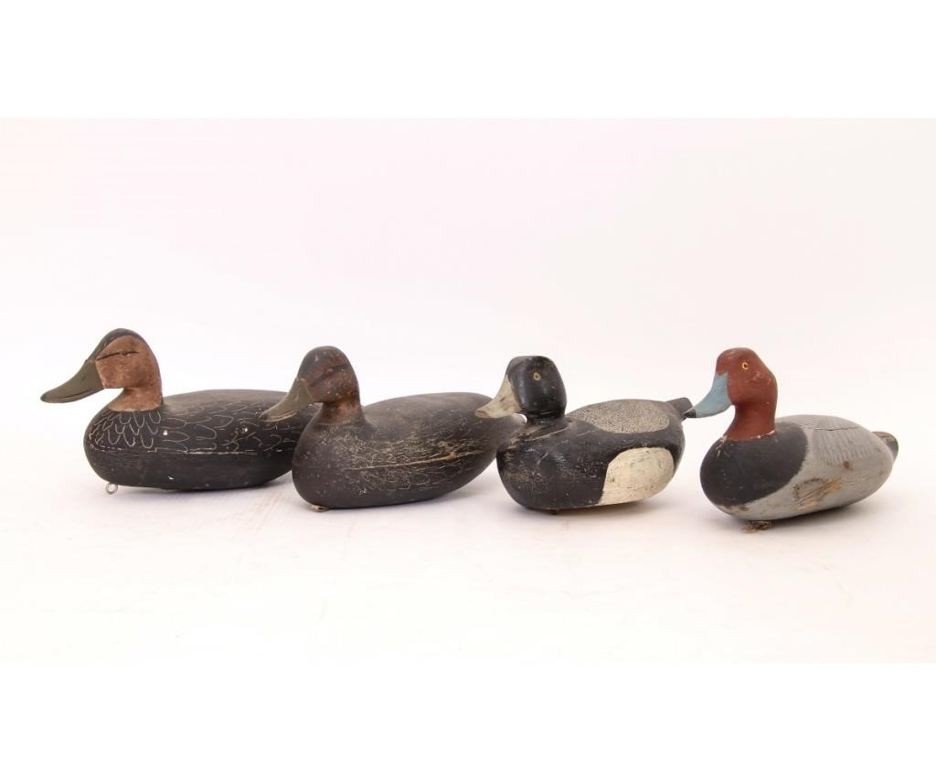 Appraisal: Four carved duck decoys to include a canvas back cracks