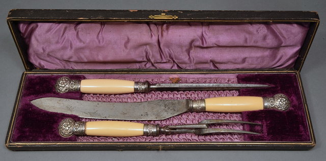 Appraisal: A CASED THREE PIECE CARVING SET with ivory handles and