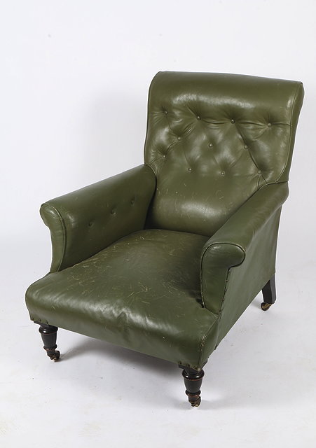 Appraisal: A GREEN LEATHER UPHOLSTERED BUTTON BACK ARMCHAIR standing on turned