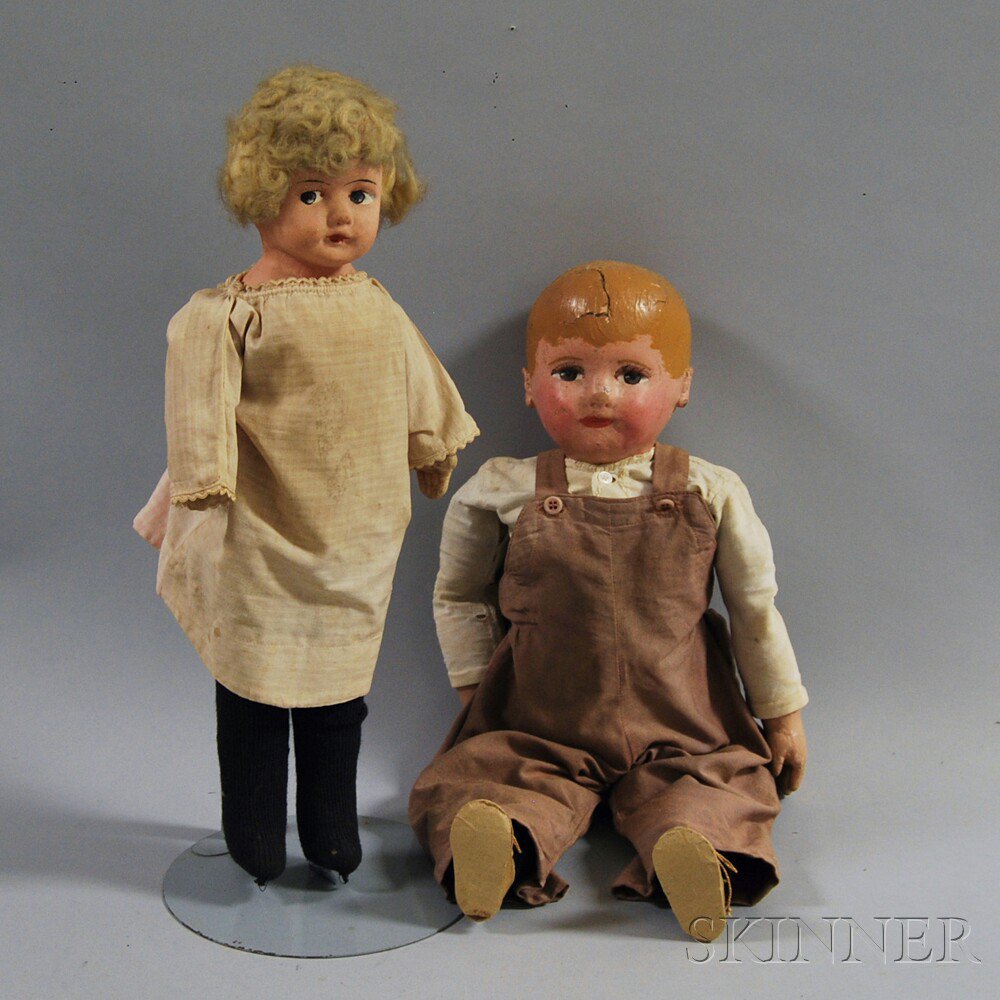 Appraisal: Two Papier-mache Dolls an oil-painted boy doll with papier-mache head