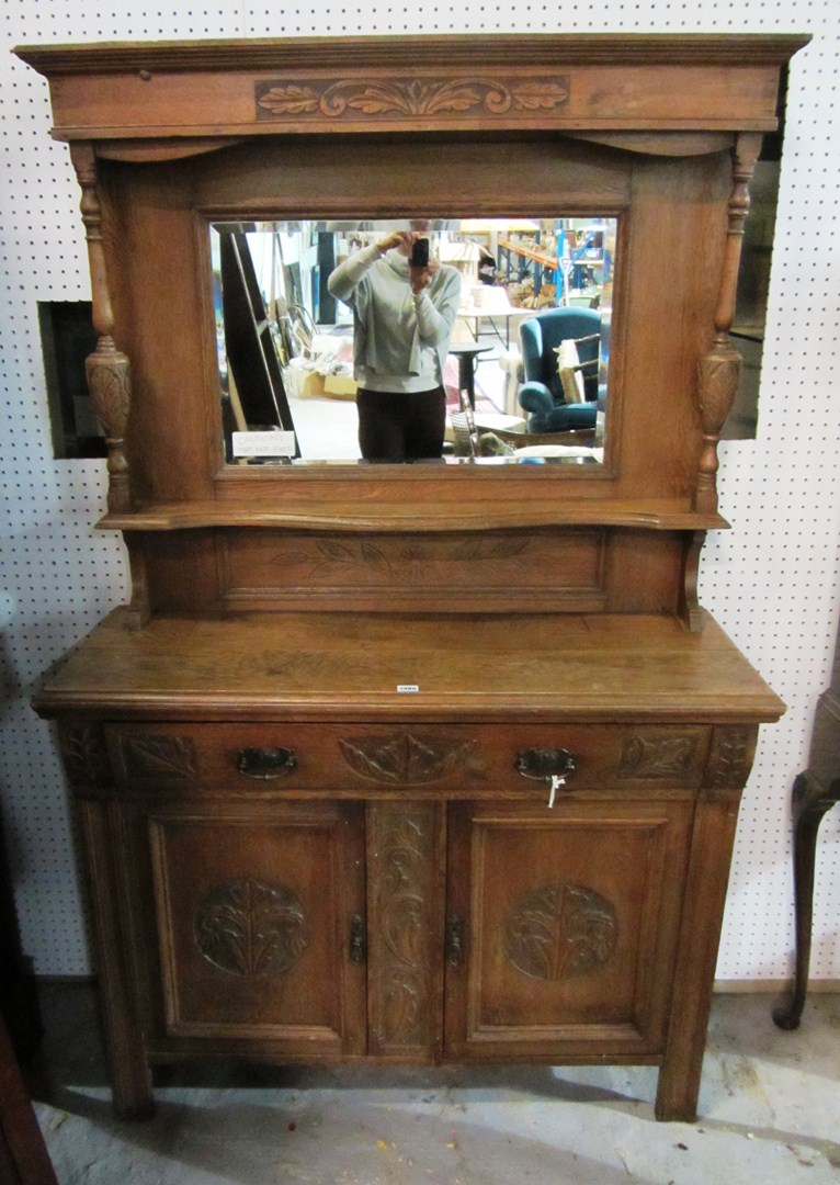 Appraisal: An oak carved sideboard with mirror back