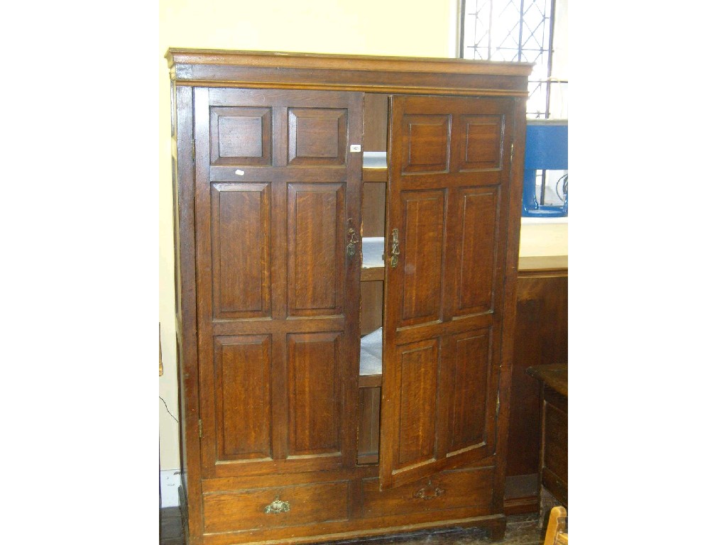 Appraisal: A Georgian oak hanging cupboard enclosed by two panel doors