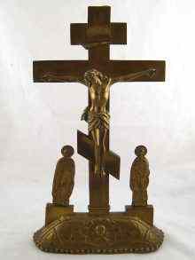 Appraisal: An enamelled brass Russian Orthodox crucifix with attendants icon