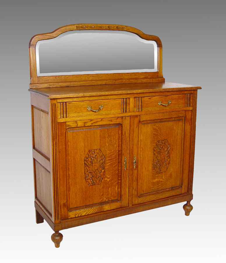 Appraisal: GOLDEN OAK SIDEBOARD WITH MIRRORED BACK SPLASH drawer over doors