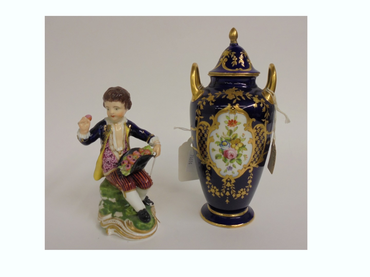 Appraisal: A Derby porcelain figure of a young boy seated with