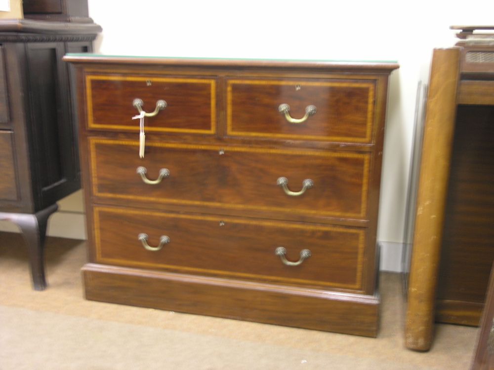 Appraisal: An Edwardian inlaid mahogany chest two short and two long