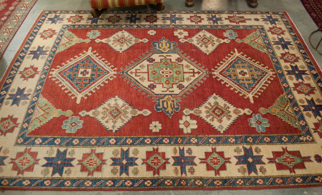 Appraisal: HAND KNOTTED ORIENTAL CARPET Pakistani-Caucasian overall geometric design on red