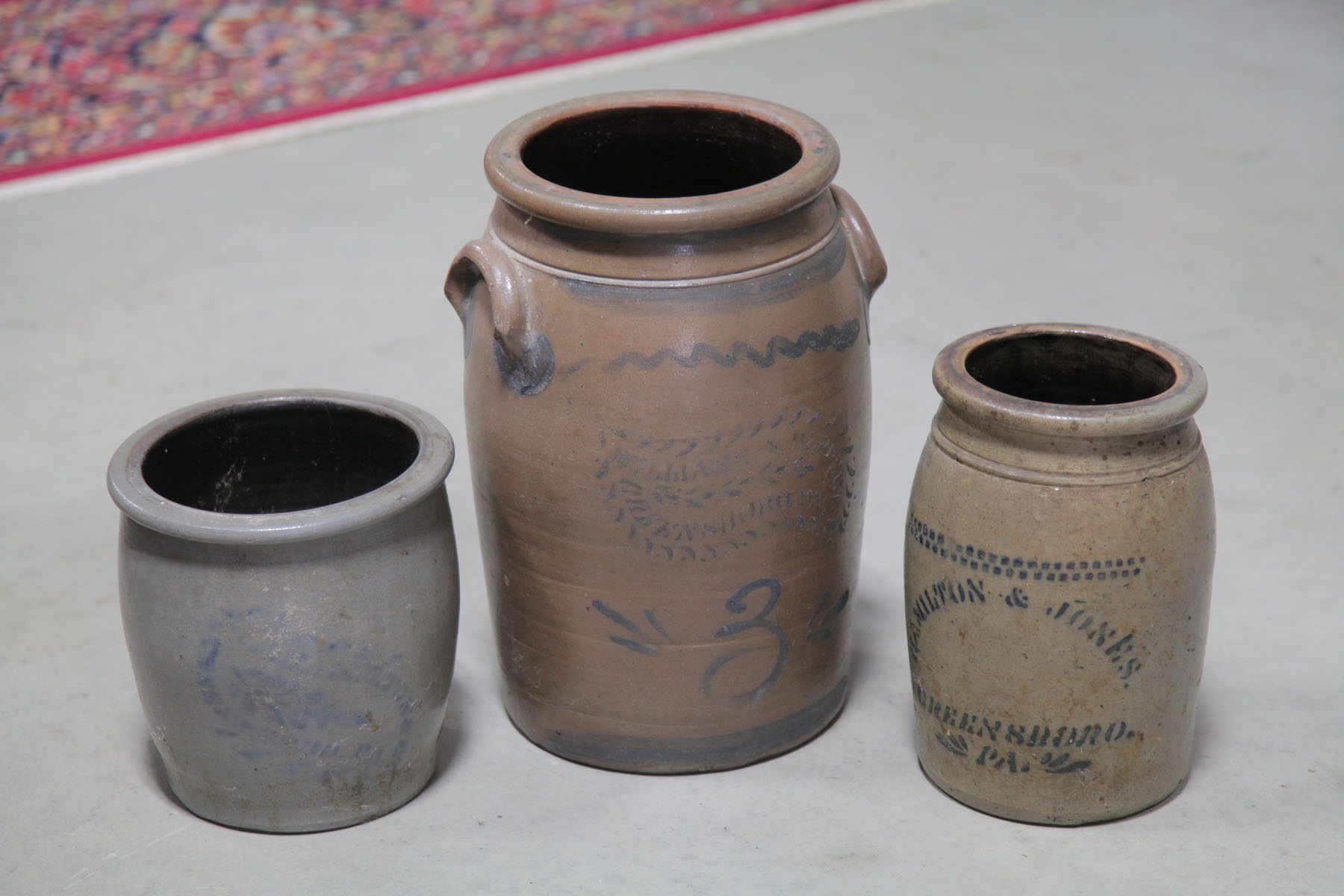 Appraisal: THREE STONEWARE CROCKS Pennsylvania late th century Stenciled cobalt decorated