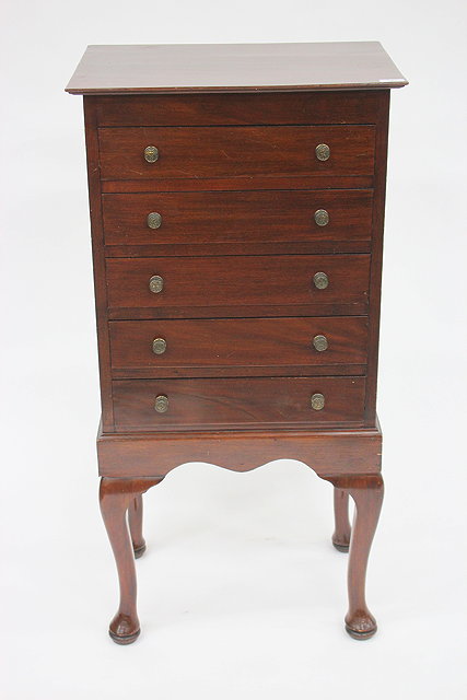 Appraisal: A MAHOGANY MUSIC CABINET fitted five long drawers with fall