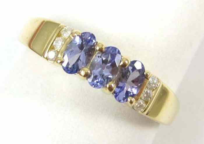 Appraisal: TANZANITE AND FOURTEEN KARAT GOLD RING set with six round-cut