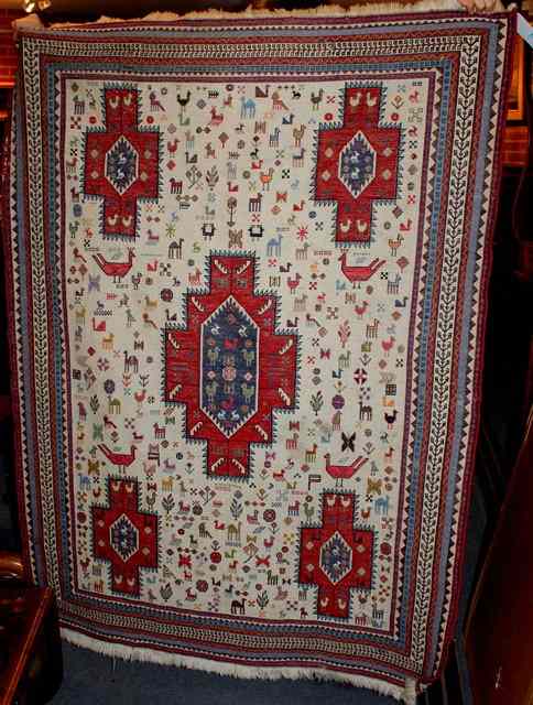 Appraisal: A PERSIAN KELIM RUG the ivory field filled with five