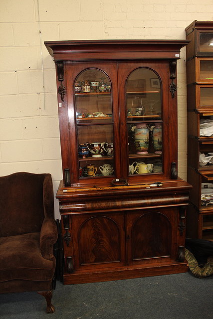 Appraisal: A VICTORIAN MAHOGANY BOOKCASE CABINET with arching glazed doors to