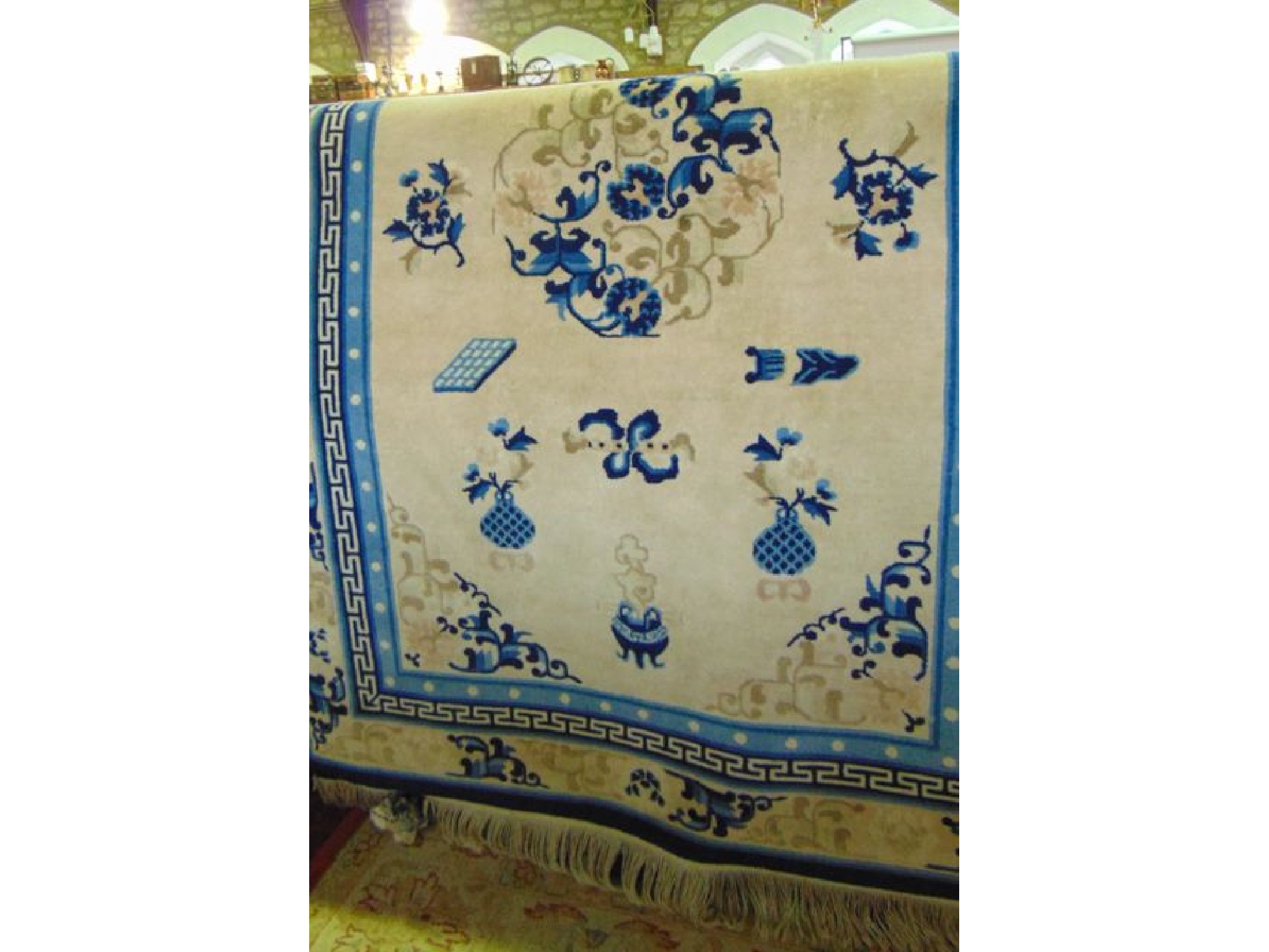 Appraisal: A Chinese blue and cream ground rug with traditional decoration