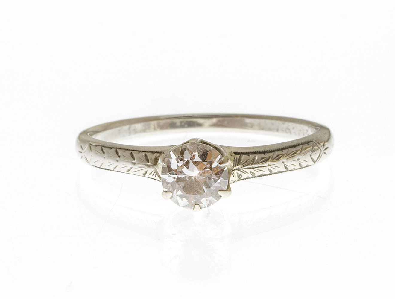 Appraisal: KT WHITE GOLD AND DIAMOND RING With a prong-set diamond