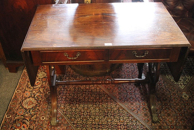 Appraisal: A REPRODUCTION MAHOGANY DROP LEAF SOFA TABLE fitted two drawers