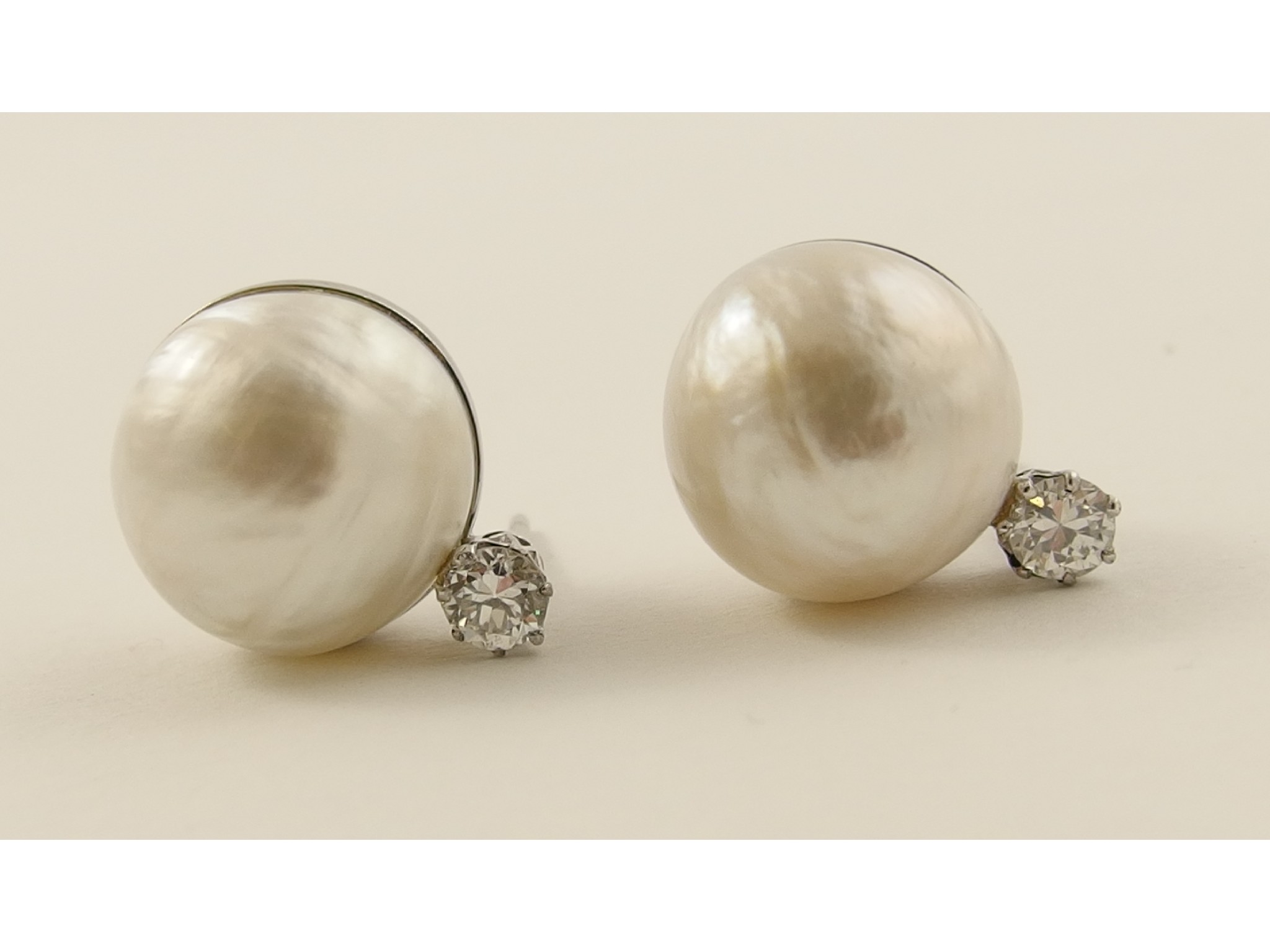 Appraisal: A pair of substantial mabe pearl and diamond earringsin unhallmarked