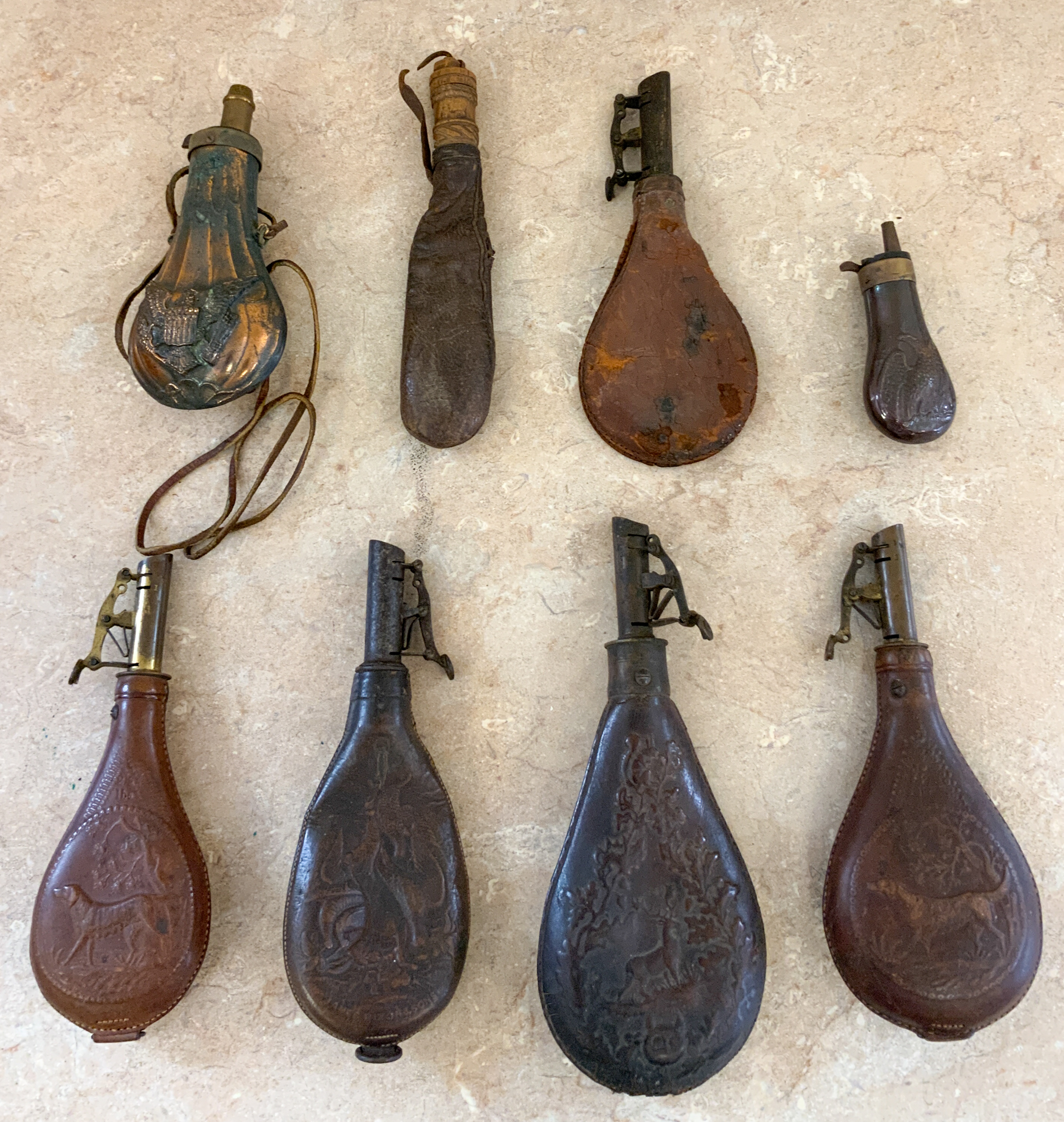 Appraisal: LEATHER POWDER HORNS AND SHOT HOLDERS Leather Powder Horns and