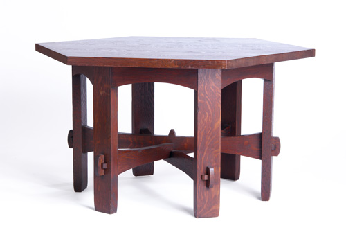 Appraisal: GUSTAV STICKLEY Hexagonal library table with trumpeted cross-stretchers mortised through