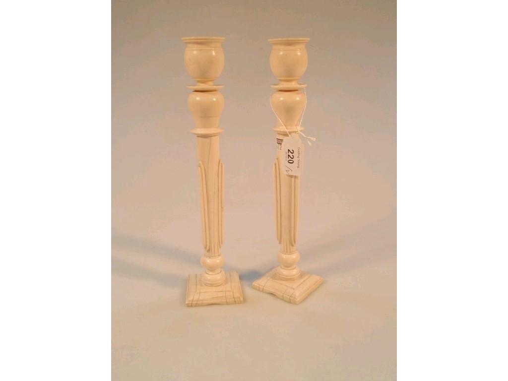 Appraisal: A pair of late thC ivory candlesticks with fixed scones