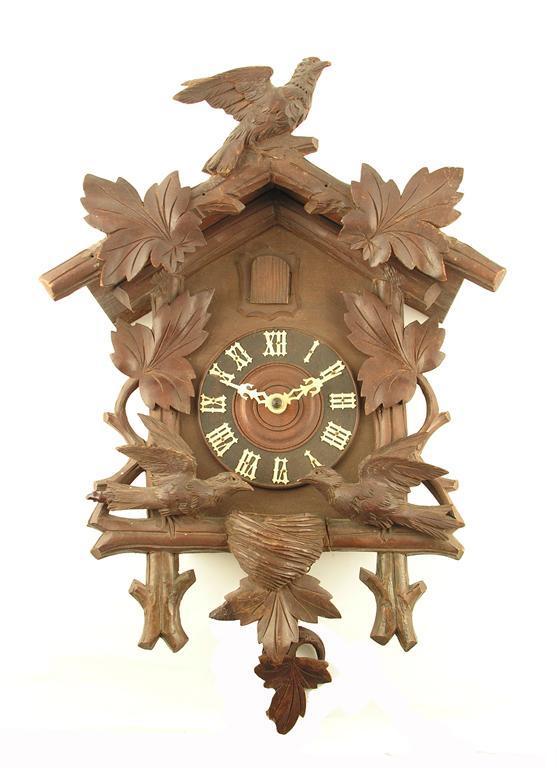 Appraisal: A Swiss carved wood cuckoo clock