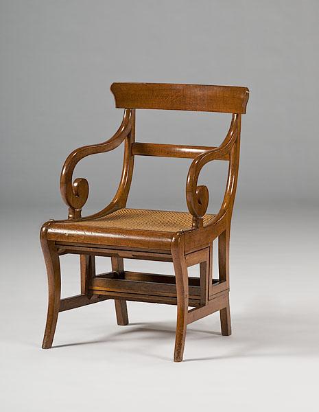 Appraisal: REGENCY METAMORPHIC OAK LIBRARY CHAIR ca The hinged seat falling