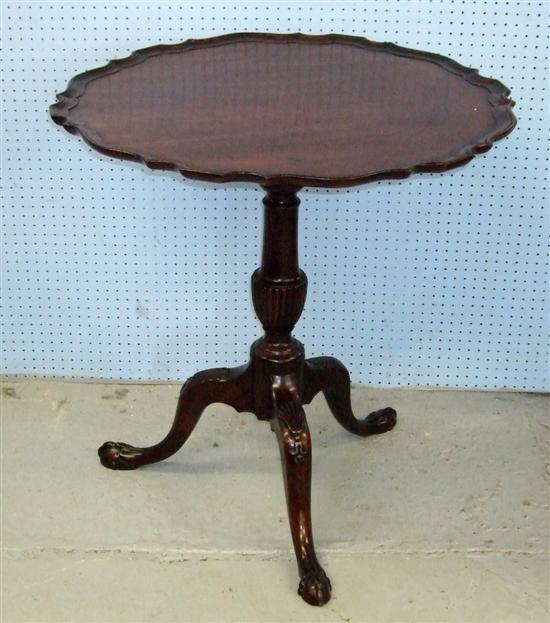 Appraisal: th century mahogany tilt top table with a carved baluster