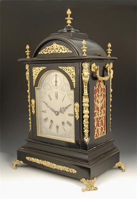 Appraisal: A large quarter chiming ebonised German mantel clock arched silvered