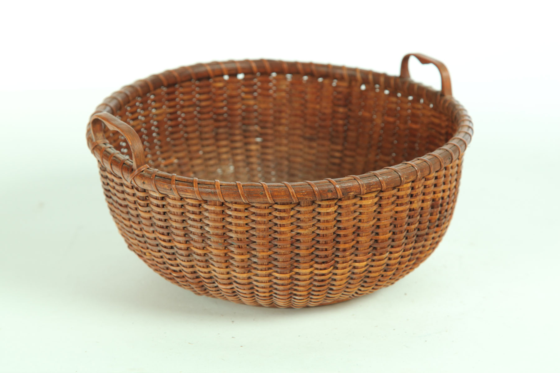 Appraisal: NANTUCKET BASKET American early th century Woven cane with two