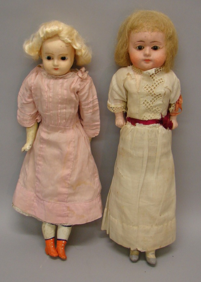 Appraisal: Pair of unmarked dolls Wax over papier mache with stationary