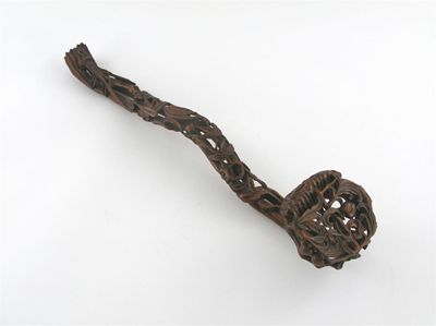 Appraisal: A Chinese carved wood sceptre the reticulated head and stem