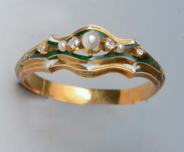 Appraisal: A FRENCH PEARL DIAMOND AND ENAMELLED HINGED BRACELET central claw