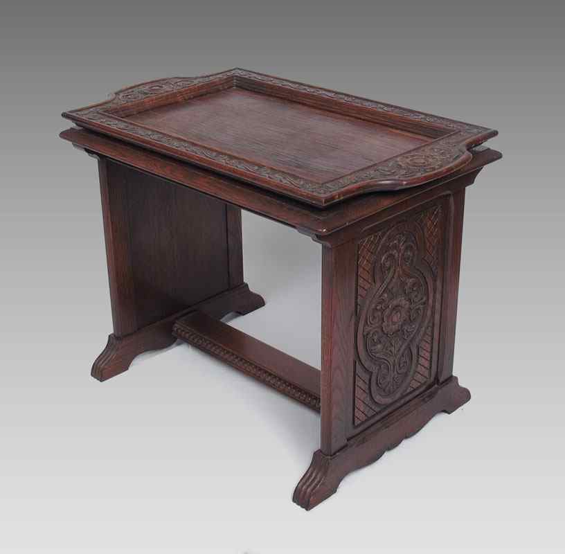 Appraisal: 's CARVED OAK TEA TABLE The lift tray framed in