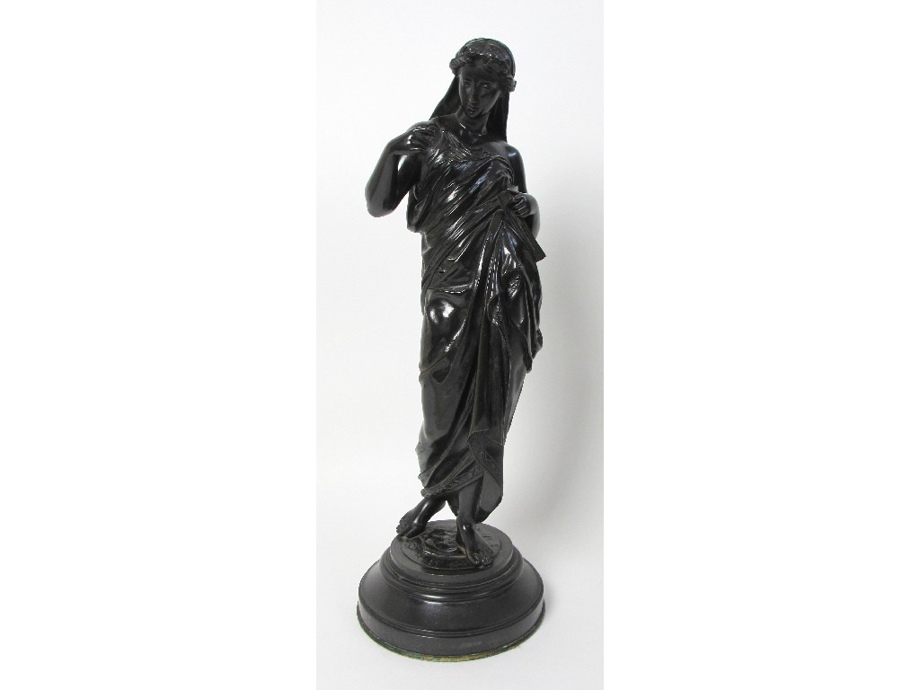 Appraisal: A bronze figure of a classical woman standing and holding