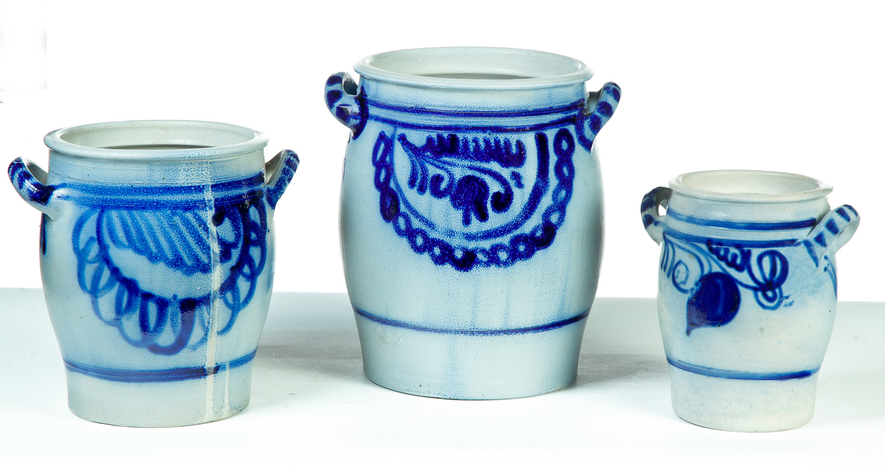 Appraisal: THREE GERMAN GRADUATED DOUBLE-HANDLED STONEWARE JARS Nineteenth century Salt glaze