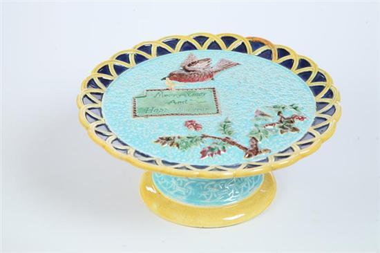 Appraisal: MAJOLICA CAKE STAND English nd half- th century Bird with