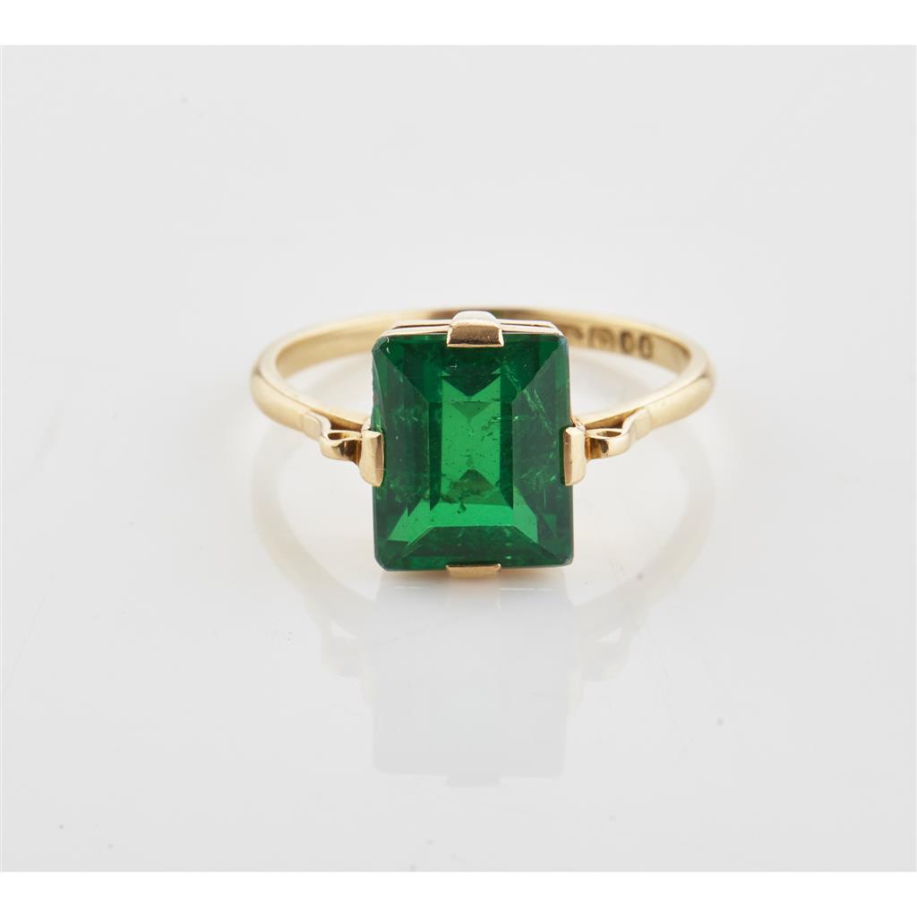 Appraisal: An emerald doublet set ring claw set with a rectangular