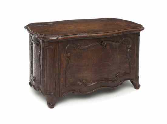 Appraisal: A Carved Oak Diminutive Chest having a shaped rectangular hinged