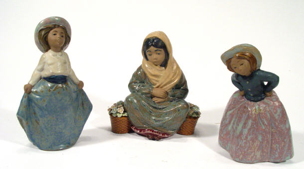 Appraisal: Two hand painted Nao porcelain figurines and a Nadal porcelain