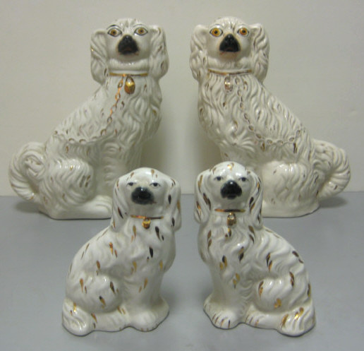 Appraisal: STAFFORDSHIRE POTTERIES ENGLAND Two pairs of seated dog figures white