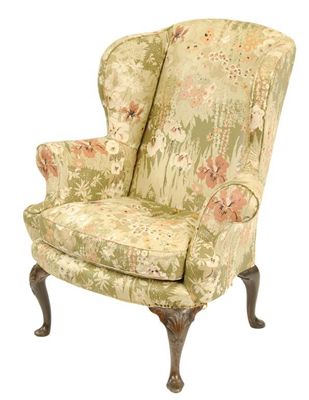 Appraisal: An early th century walnut wing armchair on shell capped