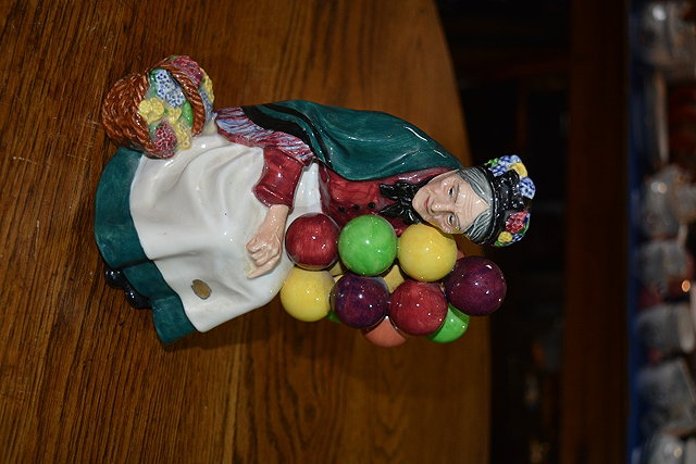 Appraisal: A Royal Doulton figureThe Old Balloon Seller HN designer L