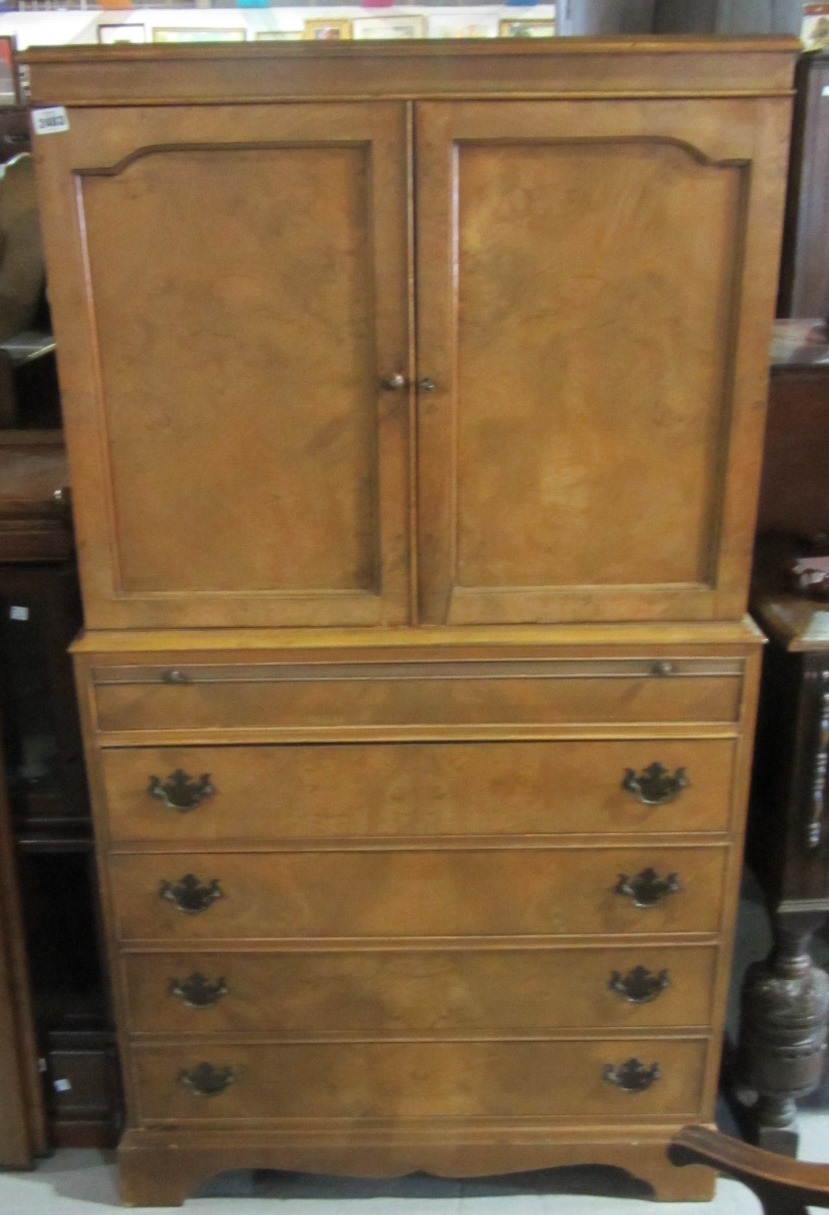 Appraisal: An early th century walnut cabinet on chest