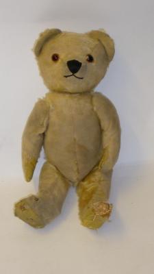 Appraisal: A mid th century English teddy bear covered in very