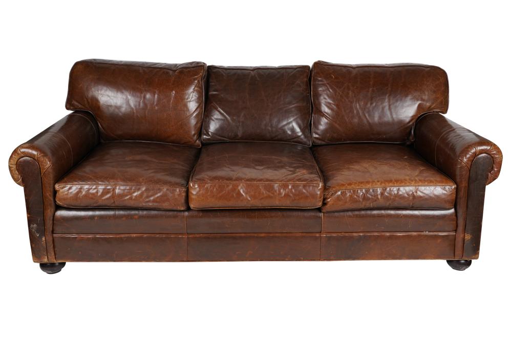 Appraisal: DISTRESSED BROWN LEATHER SOFAthe loose seat and back cushions reversing